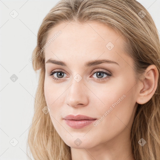 Joyful white young-adult female with long  brown hair and blue eyes