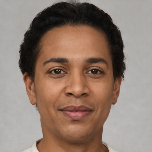 Joyful latino adult male with short  brown hair and brown eyes