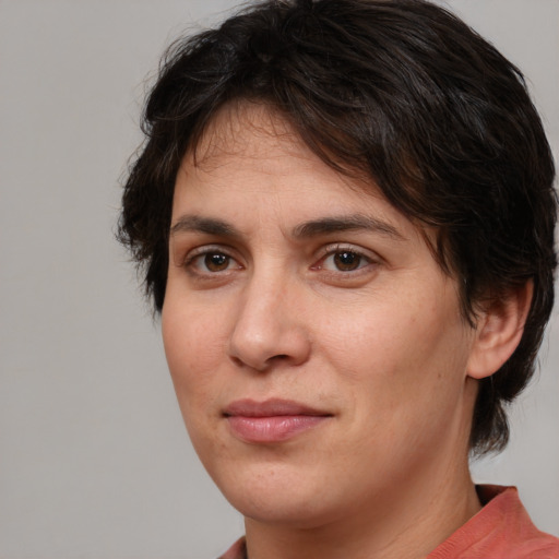 Joyful white adult female with medium  brown hair and brown eyes