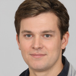 Joyful white young-adult male with short  brown hair and brown eyes