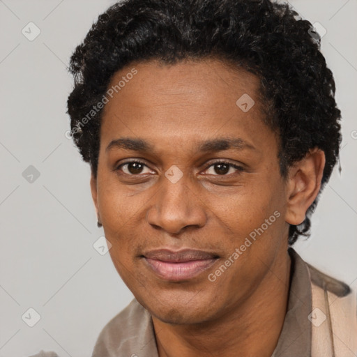 Joyful black adult male with short  black hair and brown eyes