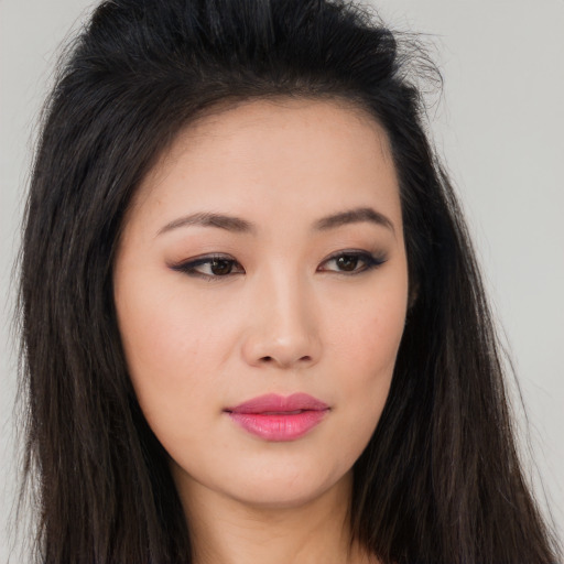 Joyful asian young-adult female with long  brown hair and brown eyes