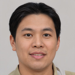 Joyful asian young-adult male with short  brown hair and brown eyes