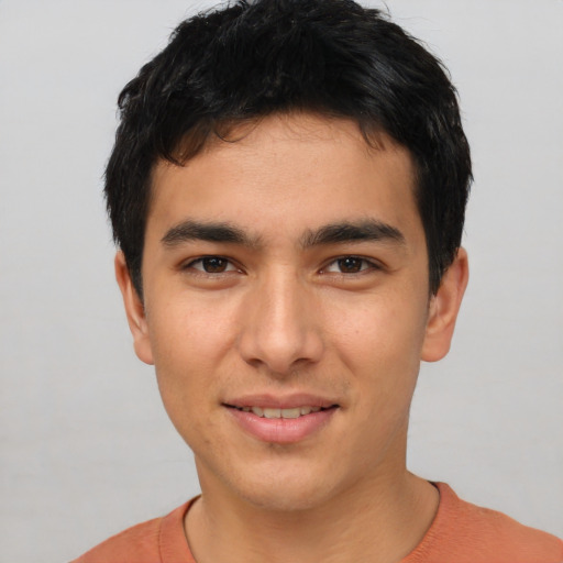 Joyful white young-adult male with short  black hair and brown eyes