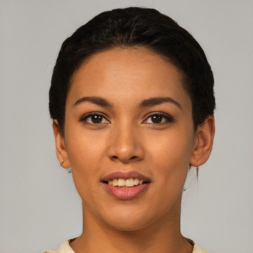 Joyful latino young-adult female with short  black hair and brown eyes