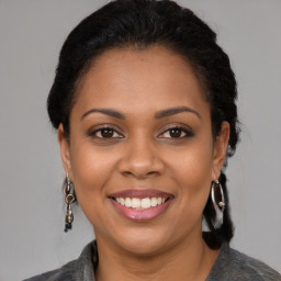 Joyful latino young-adult female with medium  brown hair and brown eyes