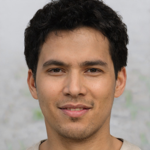Joyful asian young-adult male with short  black hair and brown eyes