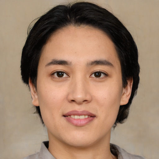 Joyful asian young-adult female with medium  black hair and brown eyes