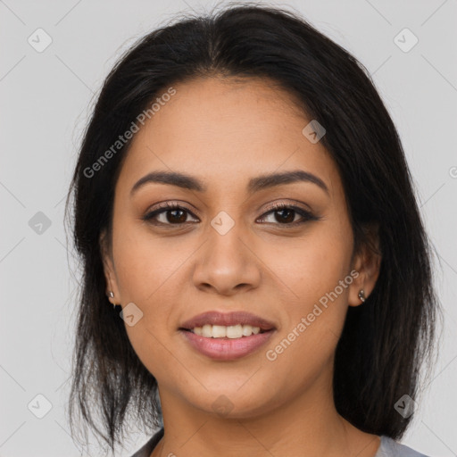 Joyful latino young-adult female with long  brown hair and brown eyes