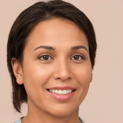 Joyful white young-adult female with medium  brown hair and brown eyes