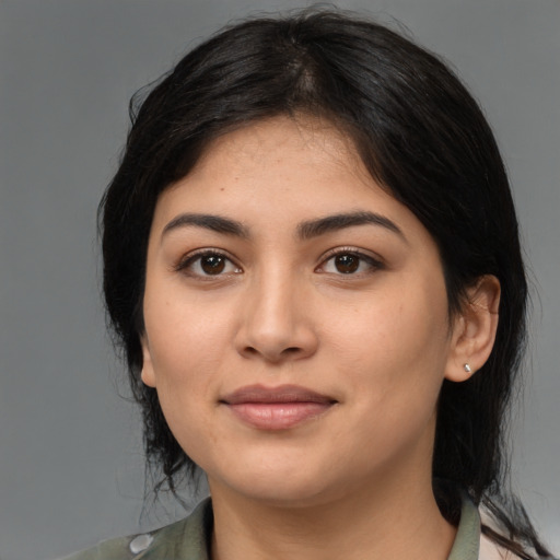 Joyful latino young-adult female with medium  black hair and brown eyes