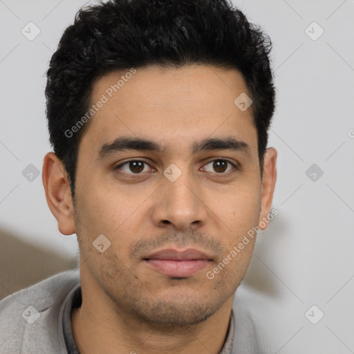 Joyful latino young-adult male with short  brown hair and brown eyes