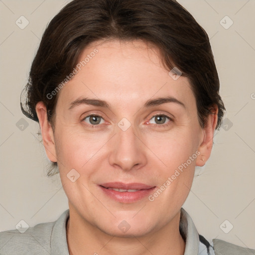 Joyful white adult female with medium  brown hair and grey eyes