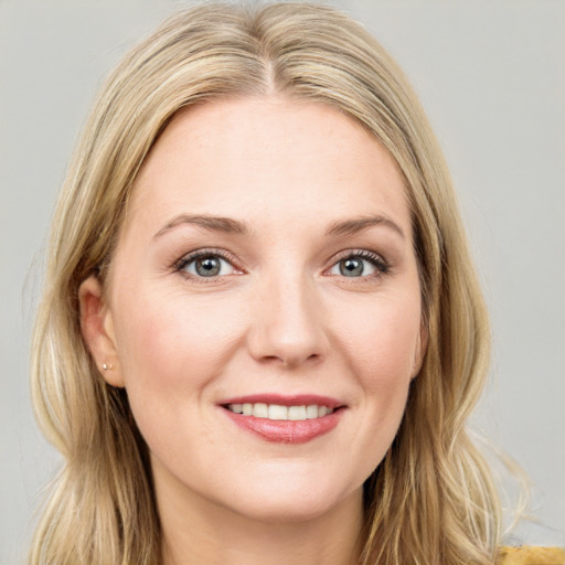 Joyful white young-adult female with long  brown hair and blue eyes