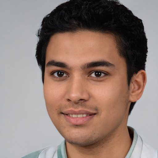 Joyful latino young-adult male with short  black hair and brown eyes