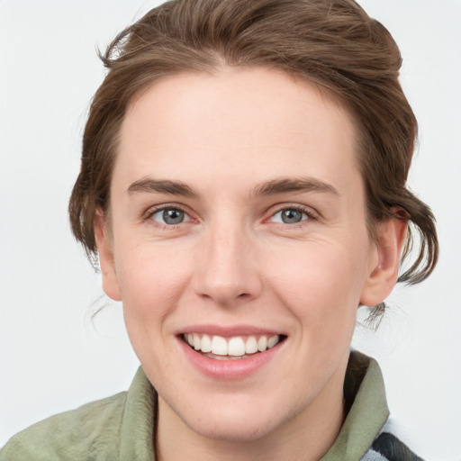 Joyful white young-adult female with medium  brown hair and blue eyes