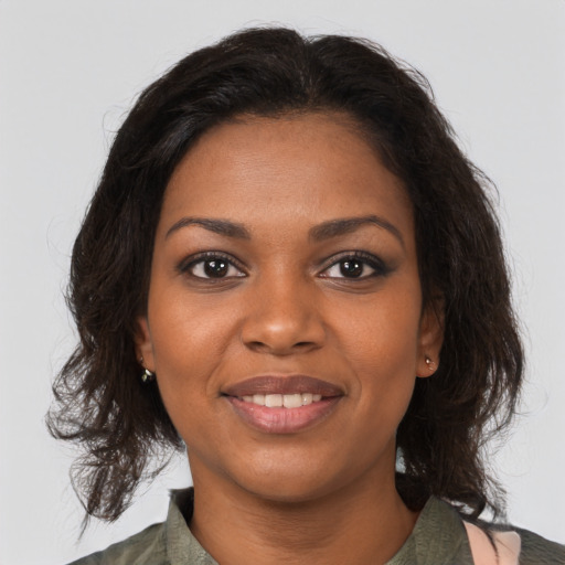Joyful black young-adult female with medium  brown hair and brown eyes