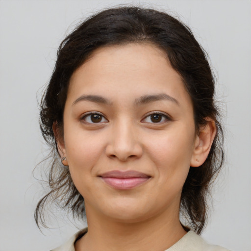 Joyful latino young-adult female with medium  brown hair and brown eyes