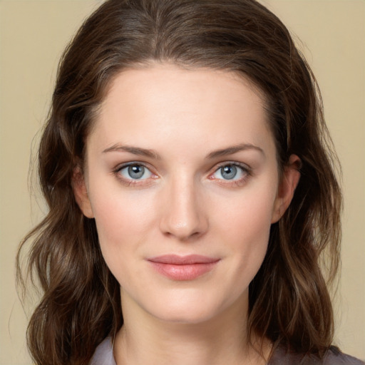 Joyful white young-adult female with medium  brown hair and green eyes