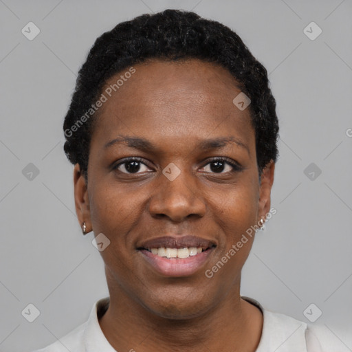 Joyful black young-adult female with short  black hair and brown eyes