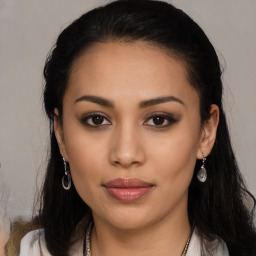 Joyful latino young-adult female with long  black hair and brown eyes