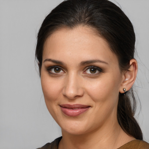 Joyful latino young-adult female with medium  brown hair and brown eyes