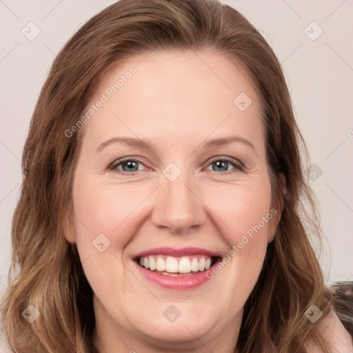 Joyful white adult female with long  brown hair and grey eyes