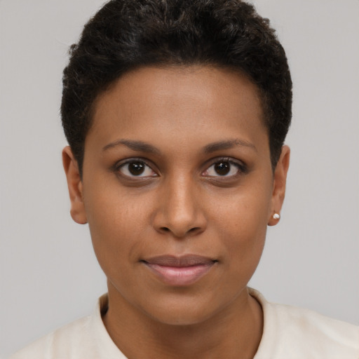 Joyful black young-adult female with short  brown hair and brown eyes