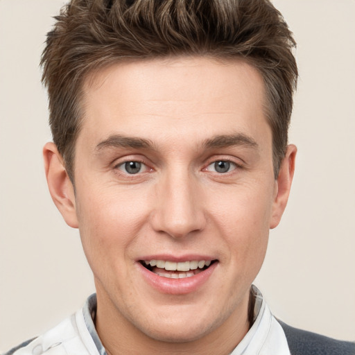 Joyful white adult male with short  brown hair and grey eyes