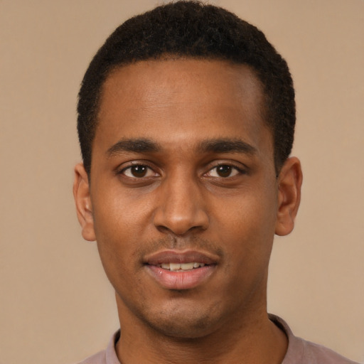 Joyful black young-adult male with short  black hair and brown eyes