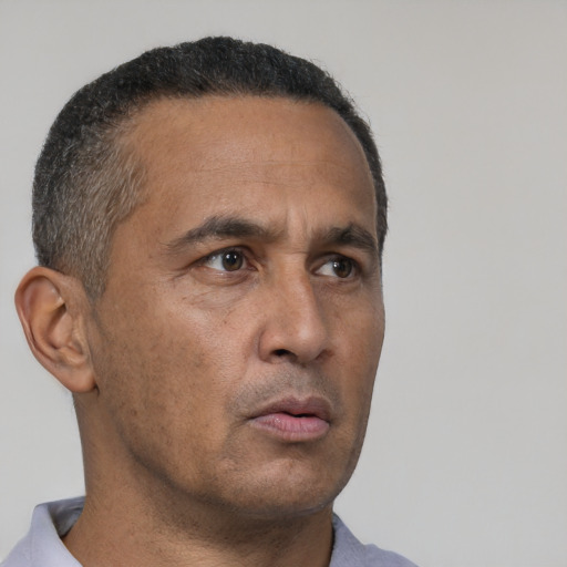Neutral latino adult male with short  black hair and brown eyes