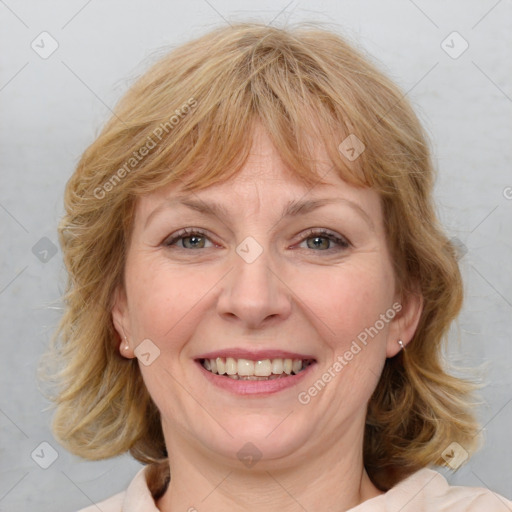 Joyful white adult female with medium  brown hair and blue eyes