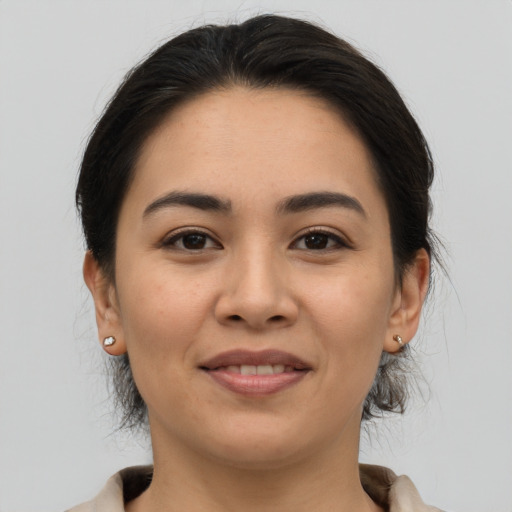 Joyful asian young-adult female with medium  brown hair and brown eyes