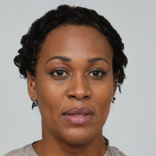 Joyful black adult female with short  black hair and brown eyes