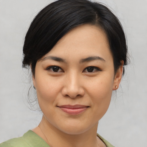 Joyful asian young-adult female with medium  black hair and brown eyes