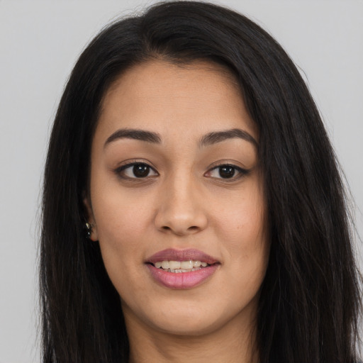 Joyful asian young-adult female with long  brown hair and brown eyes