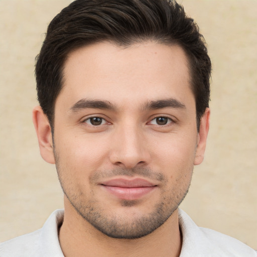 Joyful white young-adult male with short  brown hair and brown eyes