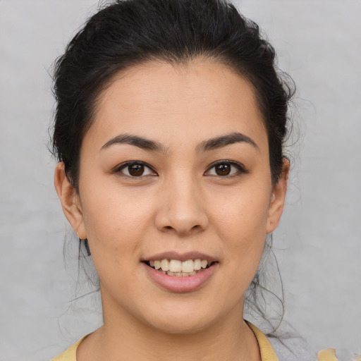 Joyful latino young-adult female with short  brown hair and brown eyes