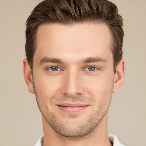 Joyful white young-adult male with short  brown hair and grey eyes