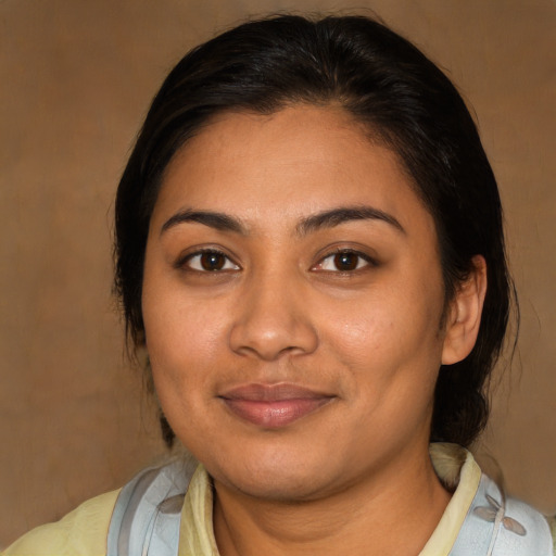 Joyful latino young-adult female with medium  brown hair and brown eyes