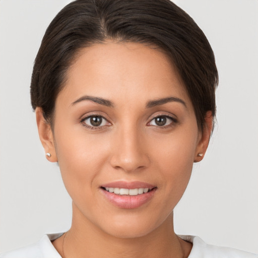 Joyful white young-adult female with short  brown hair and brown eyes