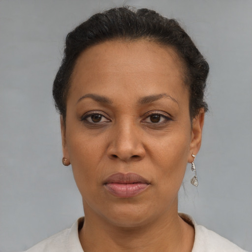 Joyful black adult female with short  brown hair and brown eyes