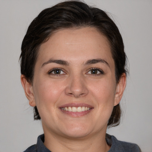 Joyful white young-adult female with medium  brown hair and brown eyes