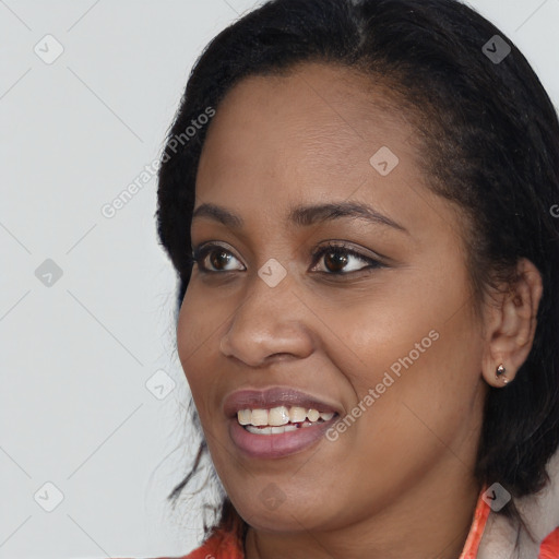 Joyful black young-adult female with long  black hair and brown eyes