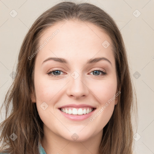 Joyful white young-adult female with long  brown hair and blue eyes