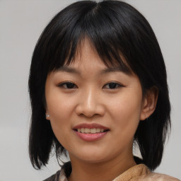 Joyful asian young-adult female with medium  black hair and brown eyes