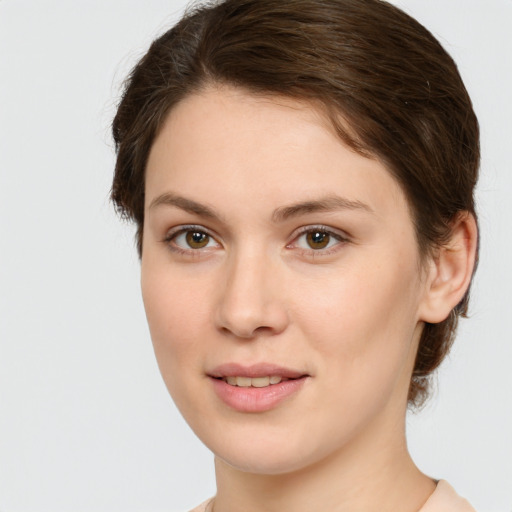 Joyful white young-adult female with medium  brown hair and green eyes