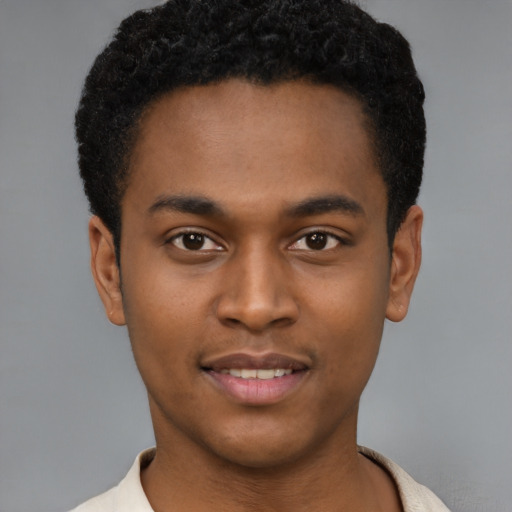 Joyful latino young-adult male with short  brown hair and brown eyes