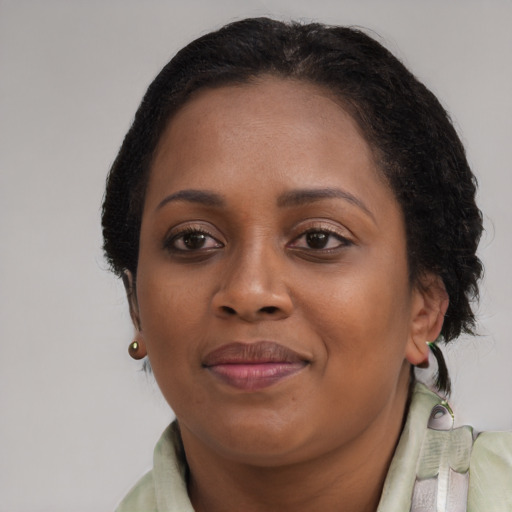 Joyful black adult female with medium  brown hair and brown eyes