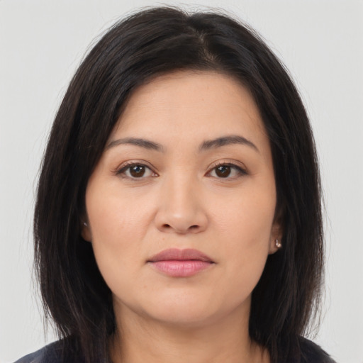 Joyful asian young-adult female with long  brown hair and brown eyes